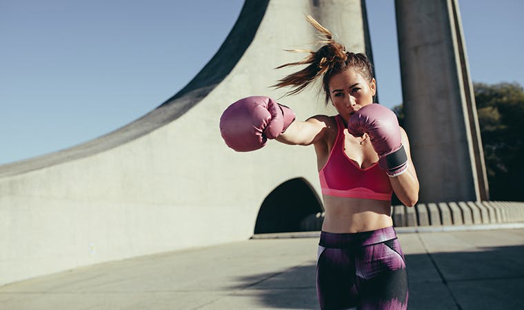 Person kickboxing outdoors