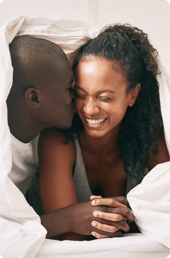 Joyful couple in bed