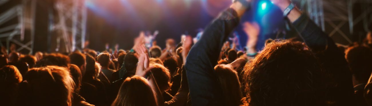 A crowd cheering at a concert