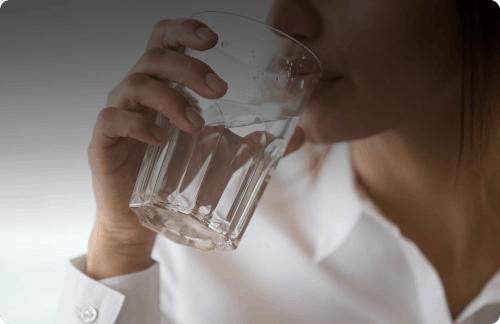 Woman drinks glass of water