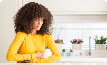 Young woman feels nauseous while suffering from a migraine.