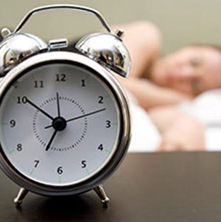 alarm clock and person sleeping 