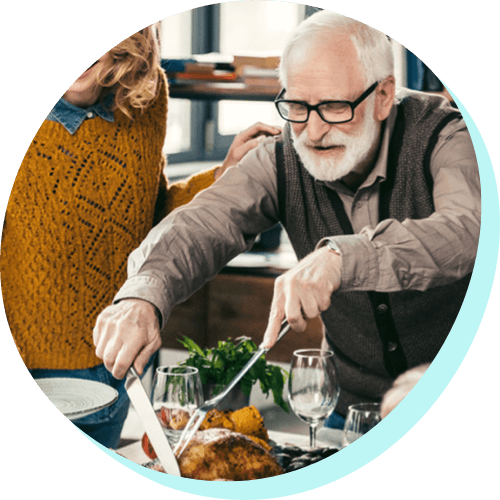 older man carving Thanksgiving Turkey