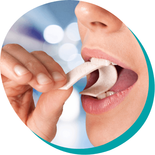 close up of a woman taking a bite out of a strip of gum