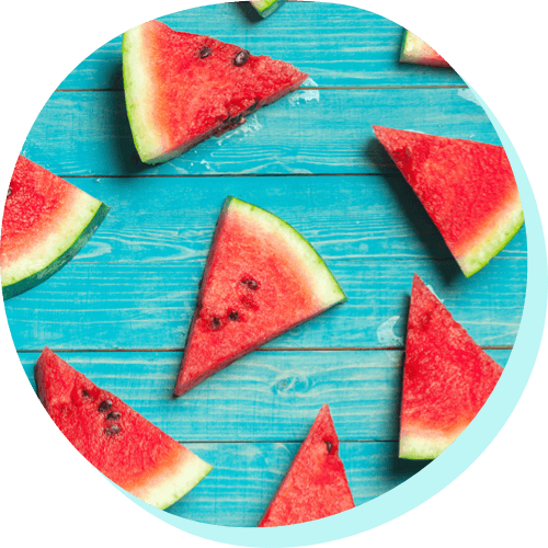 image of slices of a watermelon with a blue wood background