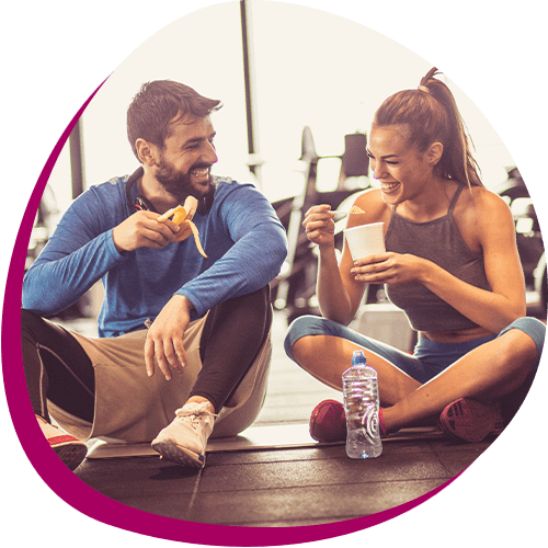 Couple enjoys a post-workout snack at the gym 