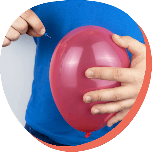 Man holding pin and balloon by stomach symbolizing getting rid of flatulence