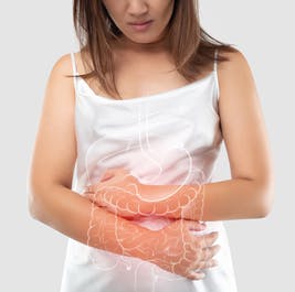 Woman holding her stomach due to intestine pain 