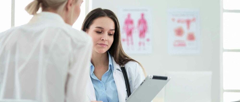 Doctor and patient talking in doctor’s office