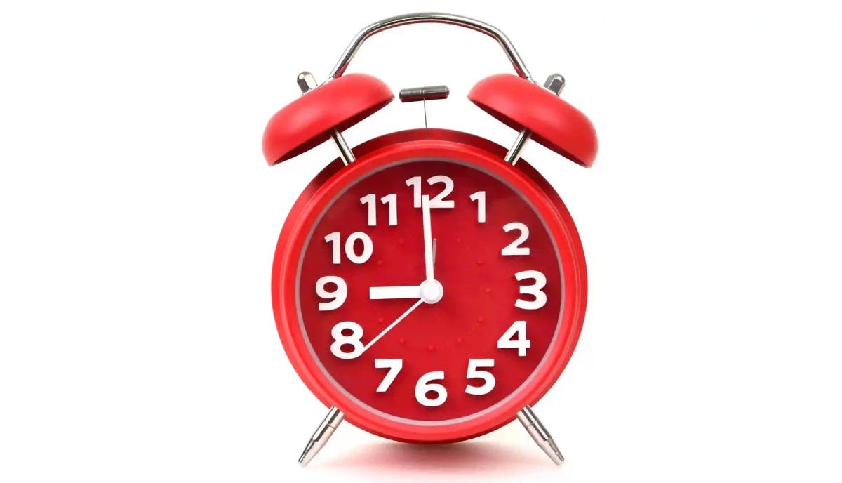 Red alarm clock near medication