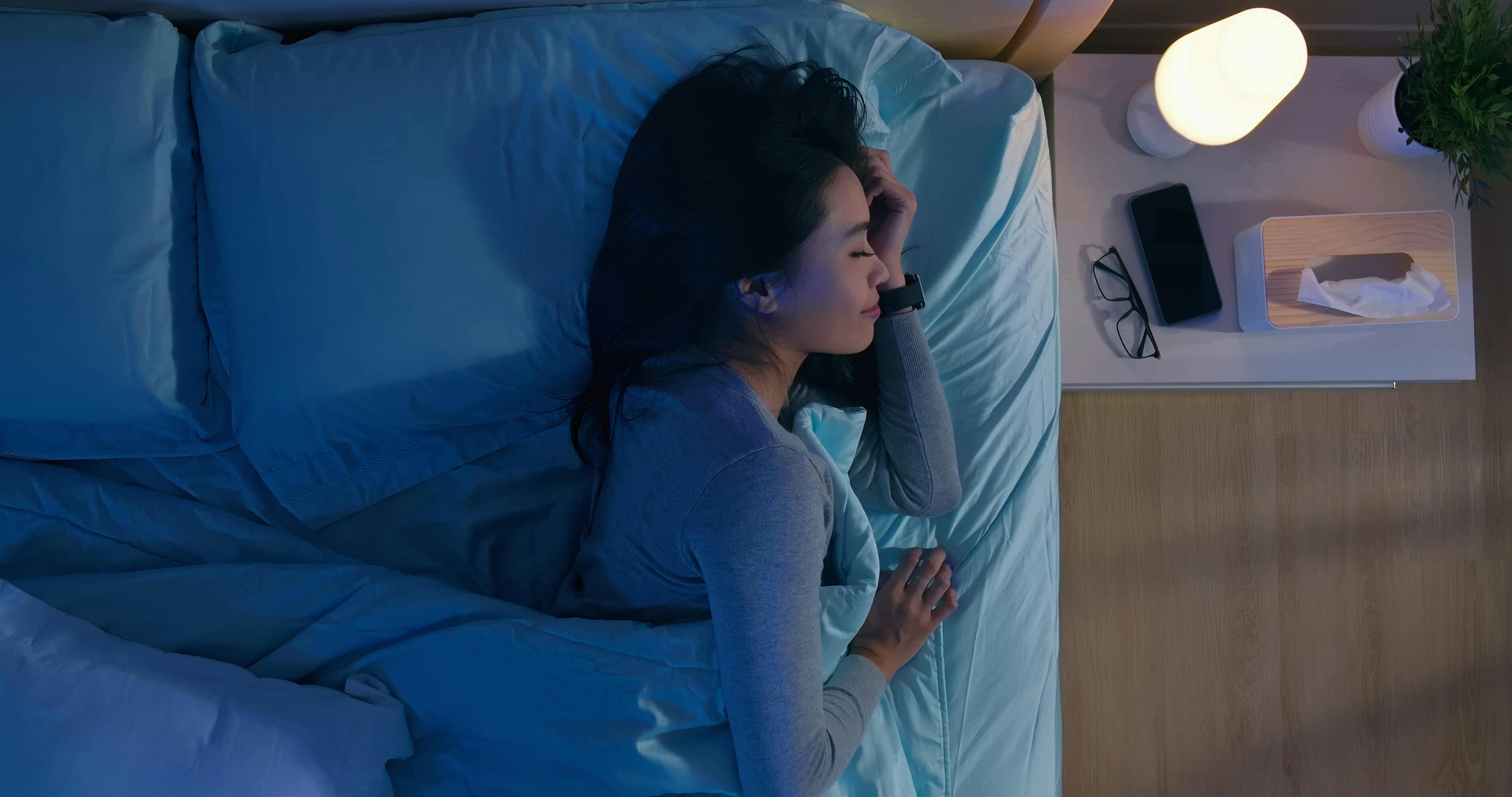 Overhead view of a woman smiling in her sleep