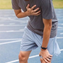 Man holding his chest after running