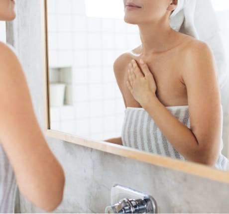 Woman wearing a towel in bathroom Woman wearing a towel in bathroom