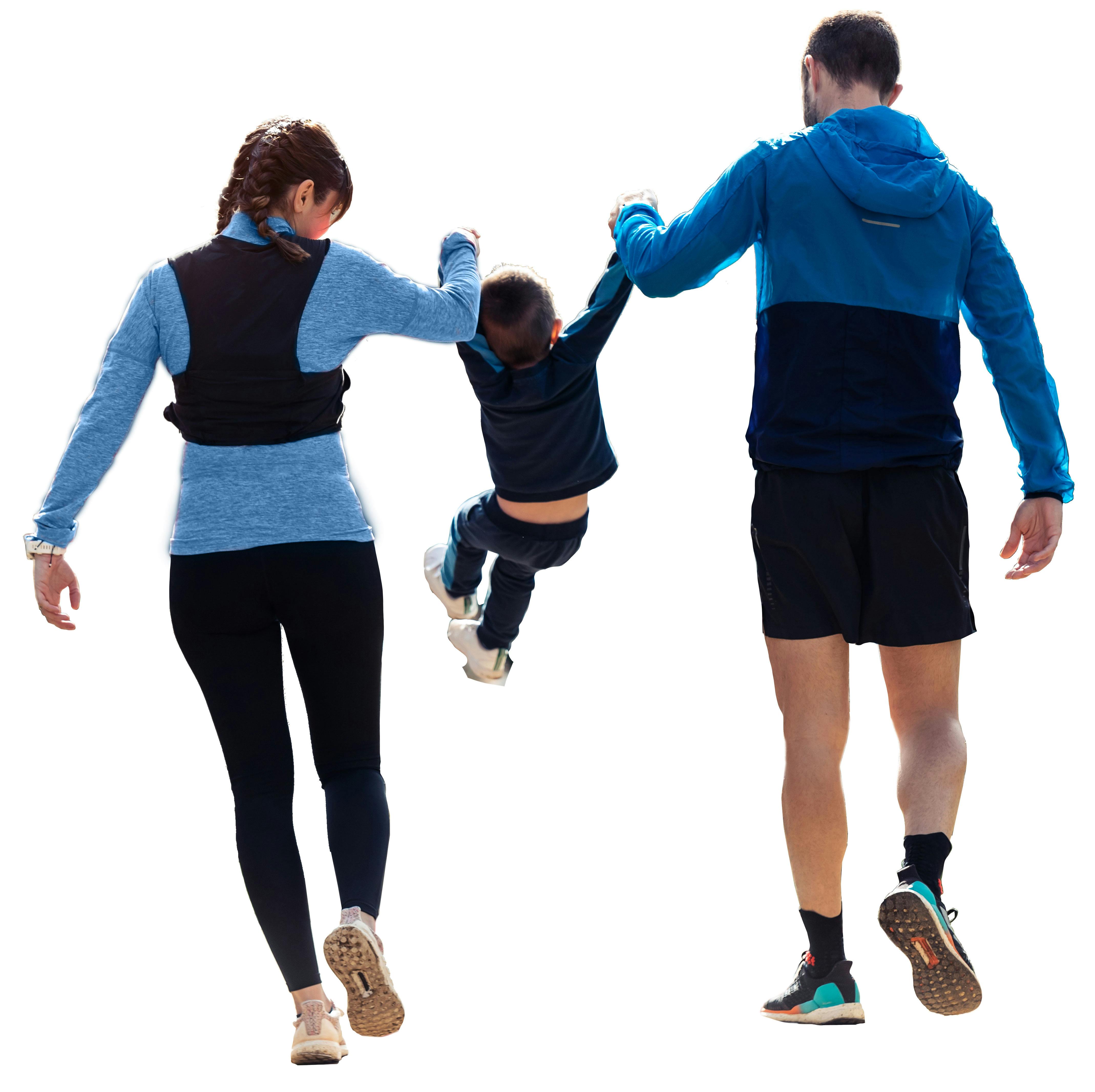 Back of Woman and Man swinging child by the arms between them