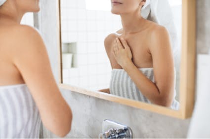 Woman wearing a towel in bathroom Woman wearing a towel in bathroom