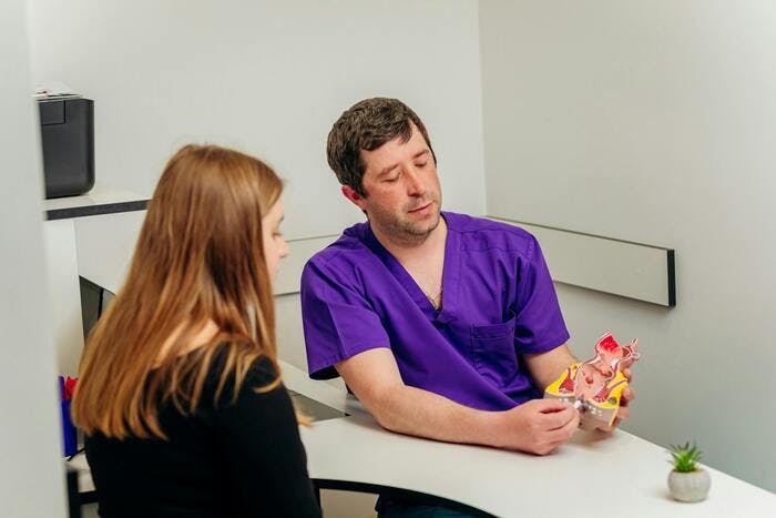 Doctor discussing hemorrhoids with a patient