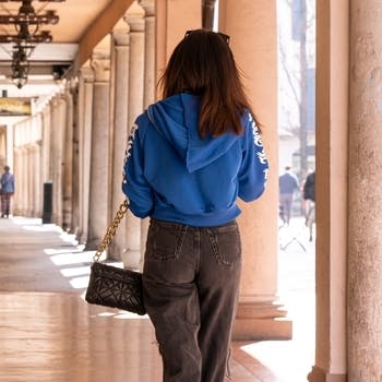 woman walking away through shopping street