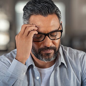 Man touching his forehead