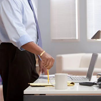 Person standing next to the office table