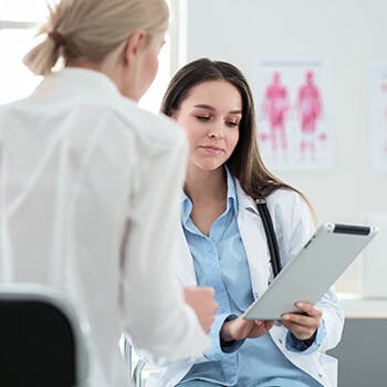 Doctor showing patient notes Doctor showing patient notes