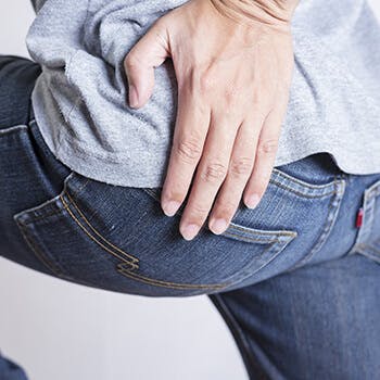 Person tending to their butt Person tending to their butt