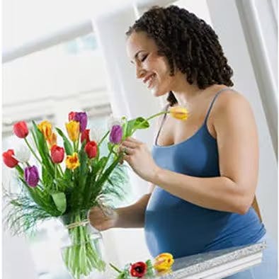 Woman embracing newborn