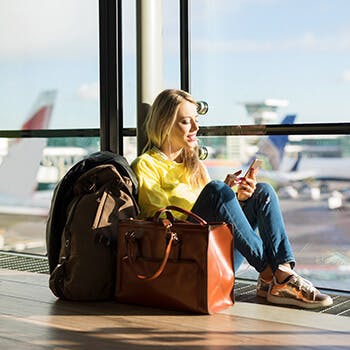 Woman on her phone at airport