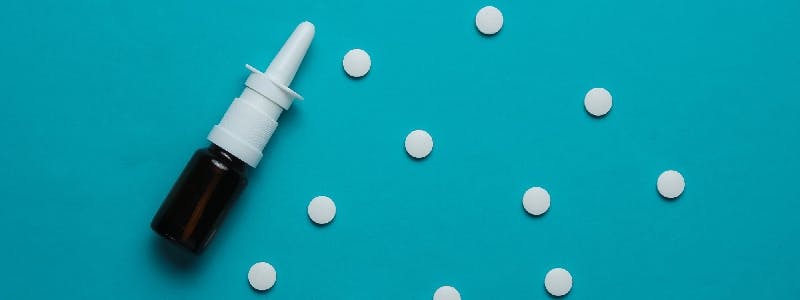 White pills and nasal spray bottle White pills and nasal spray bottle