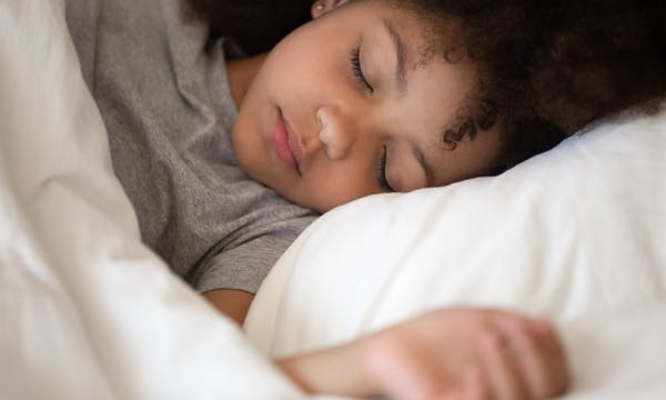 Young girl sleeping in bed