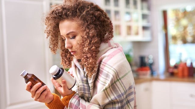 Woman looking at cough medicines