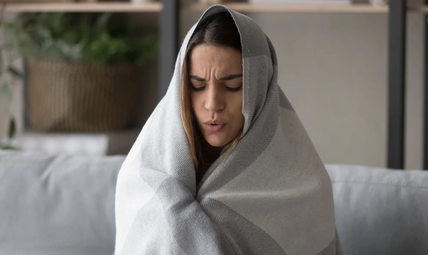 Woman wrapped in blanket.