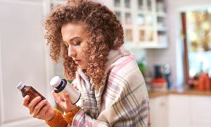 Woman looking at cough medicines