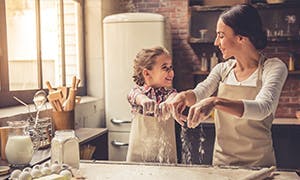 Mother and daughter baking together