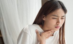 Woman with a sore throat from post-nasal drip