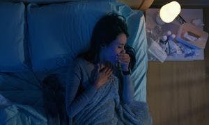 Woman coughing while she’s laying down at night Woman coughing while she’s laying down at night