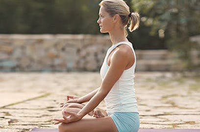 Woman meditating outside