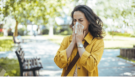 Man with a cold blowing nose into a tissue 