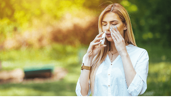 Man with a cold blowing nose into a tissue 