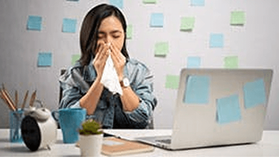 Man with a cold blowing nose into a tissue 