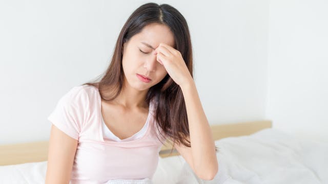 Woman experiencing a sinus headache