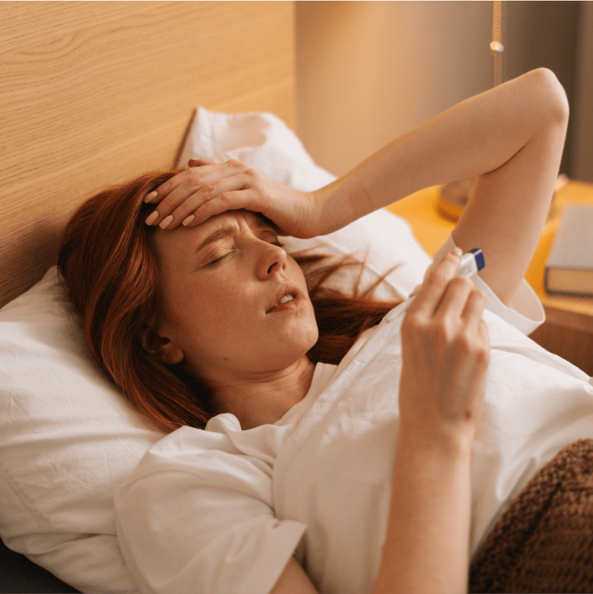 Woman sneezing into tissue