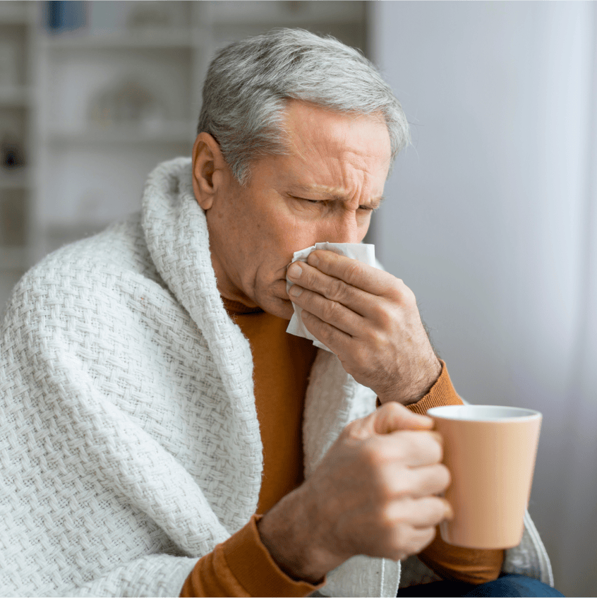 Woman sneezing into tissue