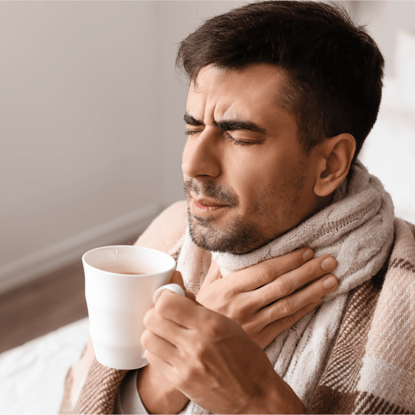 Woman sneezing into tissue