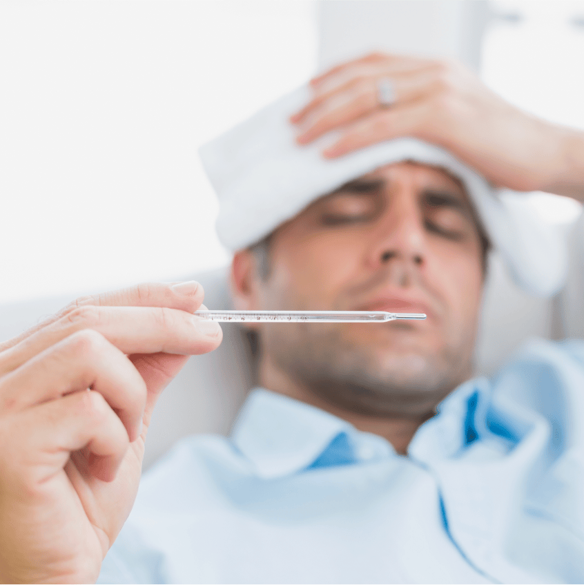 Woman sneezing into tissue