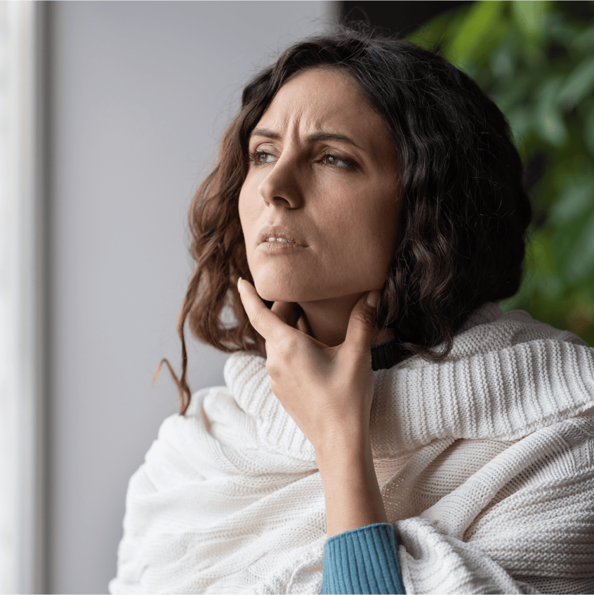 Woman sneezing into tissue