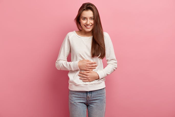 Cheerful girl with hands-on stomach