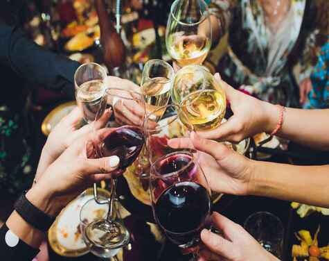 People clinking champagne and wine glasses together