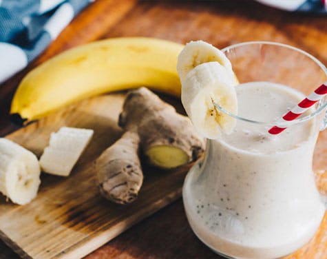 smoothie with banana and ginger on a cutting board