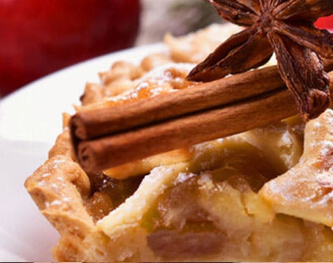 picture of pie with whole cinnamon and star anise on top of it