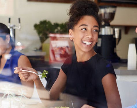 picture of woman smiling at colleague during business lunch
